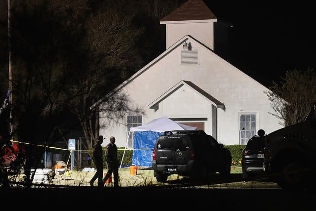 Law enforcement officials continue their investigation at Sutherland Springs Baptist Church during the early morning hours of November 6