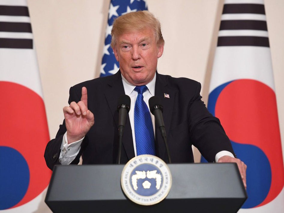 President Donald Trump gestures during a joint press conference with South Korea's President Moon Jae-in at the presidential Blue House in Seoul