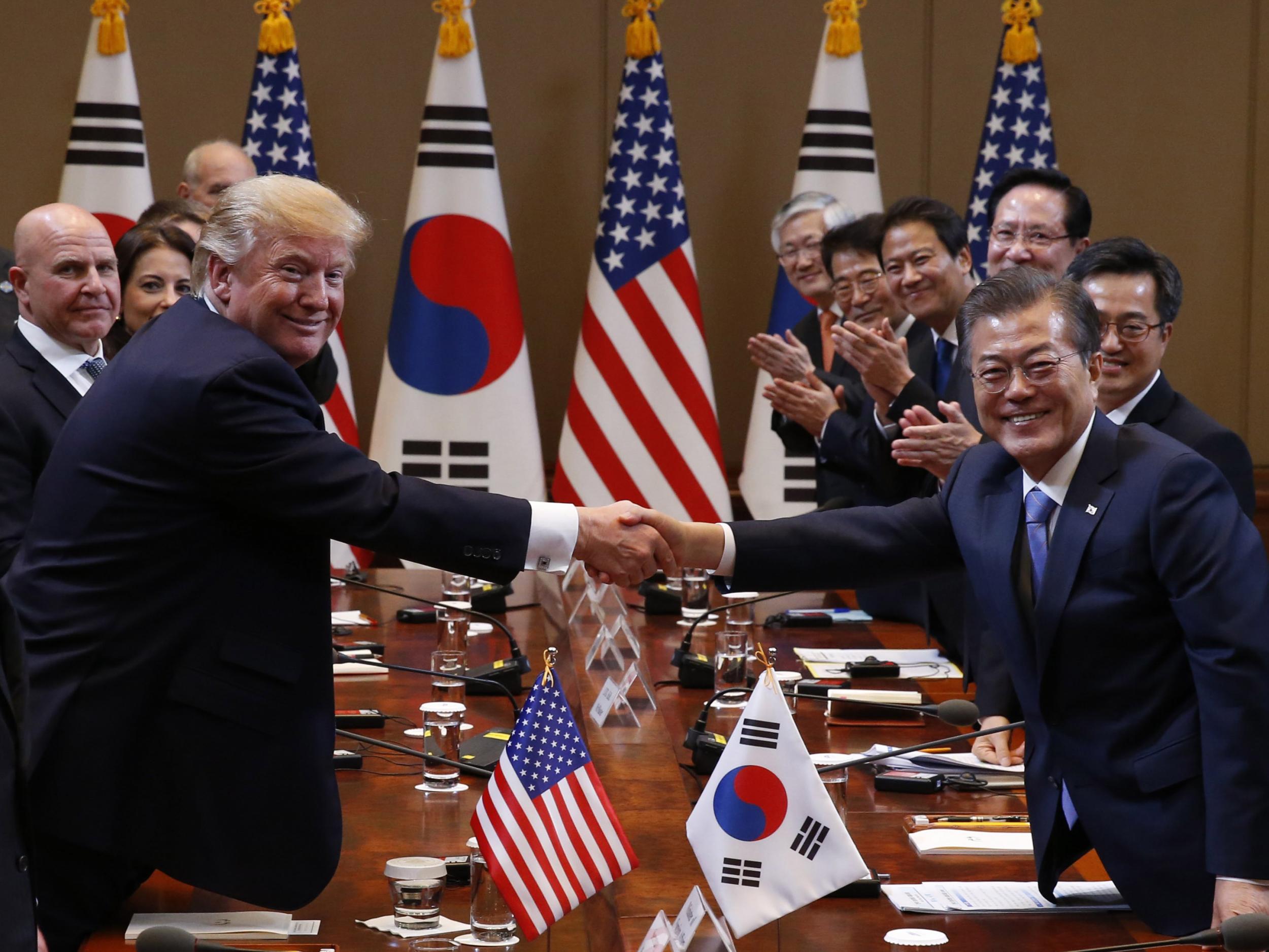 Trump and South Korean President Moon Jae-in shake hands before their summit meeting in Seoul