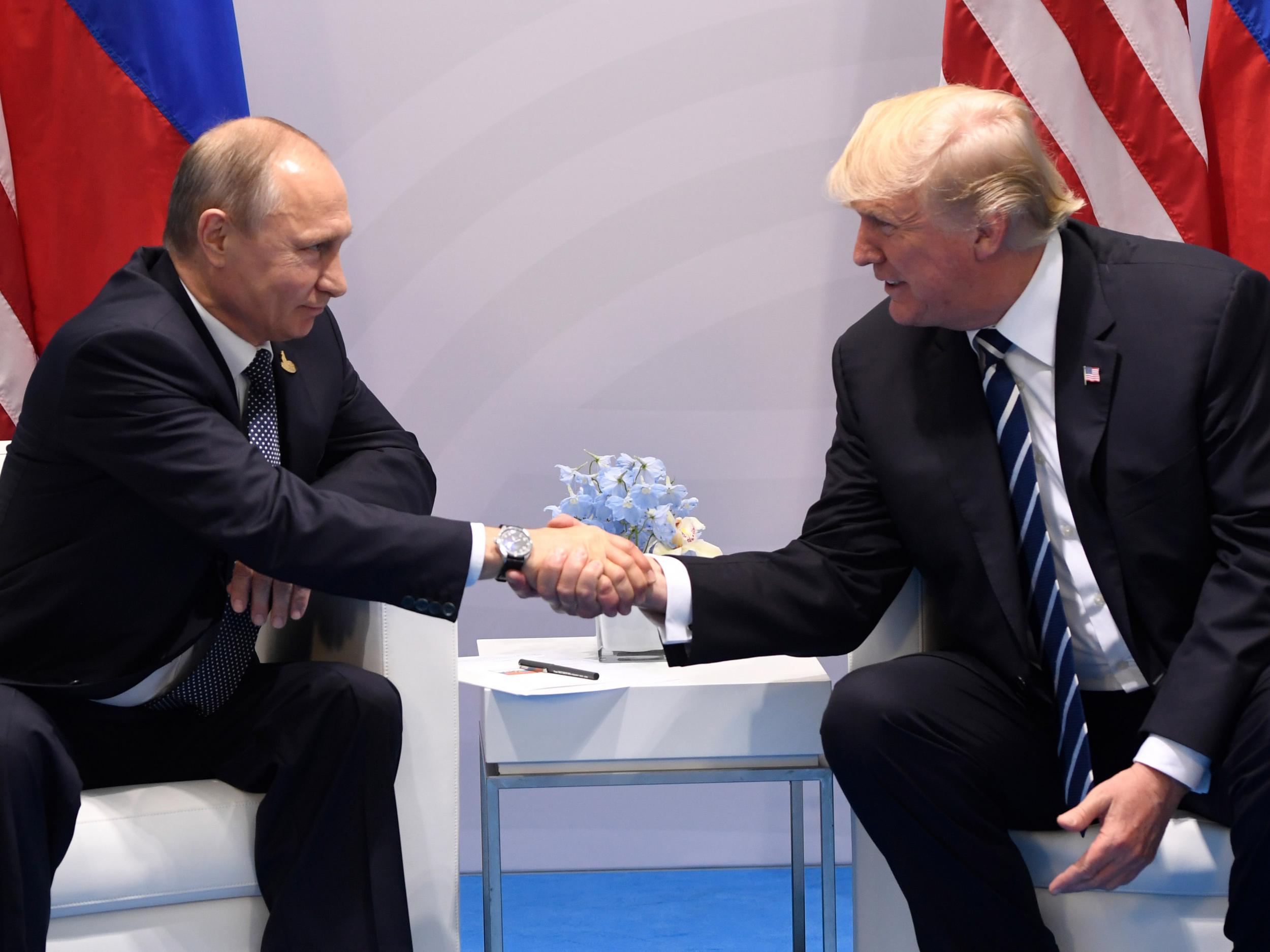 Donald Trump and Vladimir Putin shake hands during a meeting on the sidelines of the G20 Summit in Hamburg, Germany