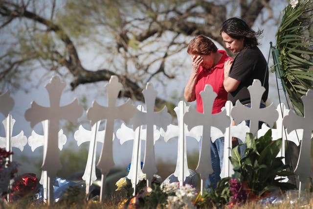 Maria Durand and her daughter, Lupita Alcoces, visit a memorial in Sutherland Springs for the victims of a mass shooting