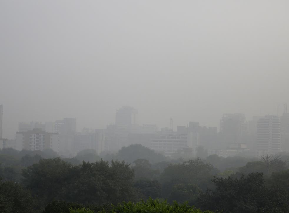 Smog envelops the skyline at noon in New Delhi, India
