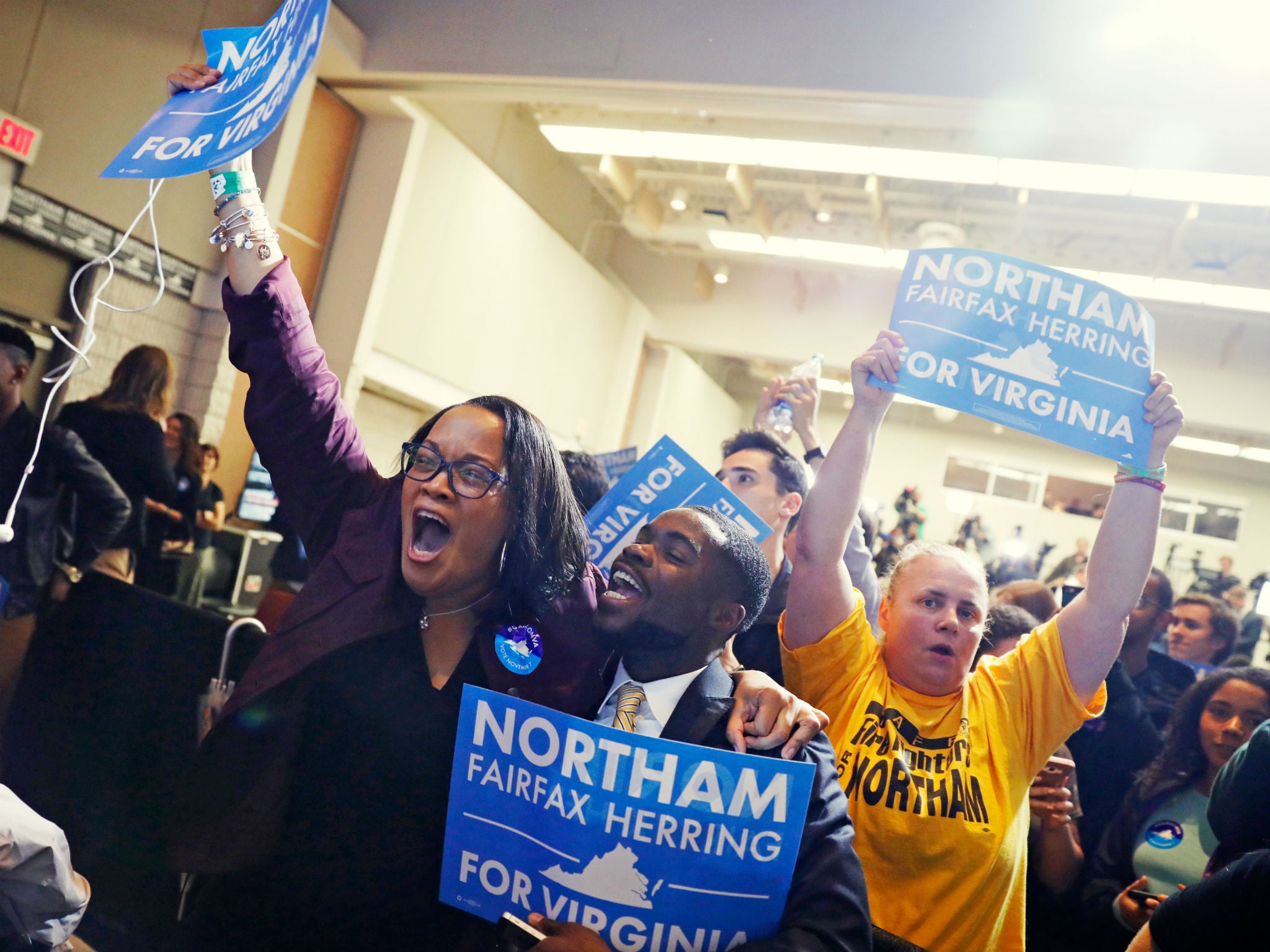 Supporters of Ralph Northam begin to celebrate as results start to come in at Northam's election night rally on the campus of George Mason University in Fairfax, Virginia, November 7, 2017
