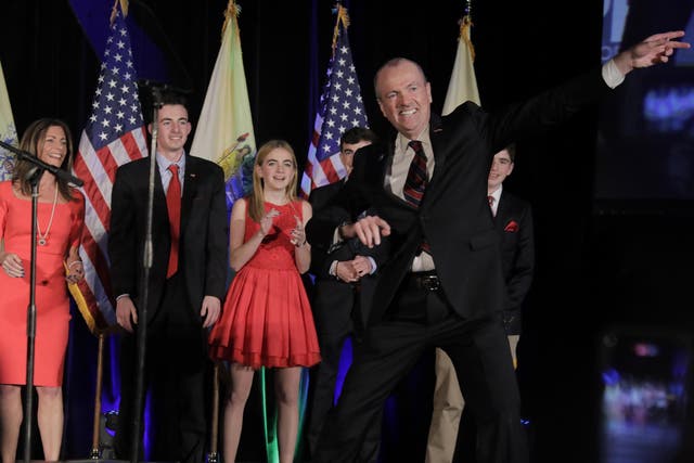A jubilant Phil Murphy celebrates on stage with his family after being elected Governor of New Jersey in Asbury Park