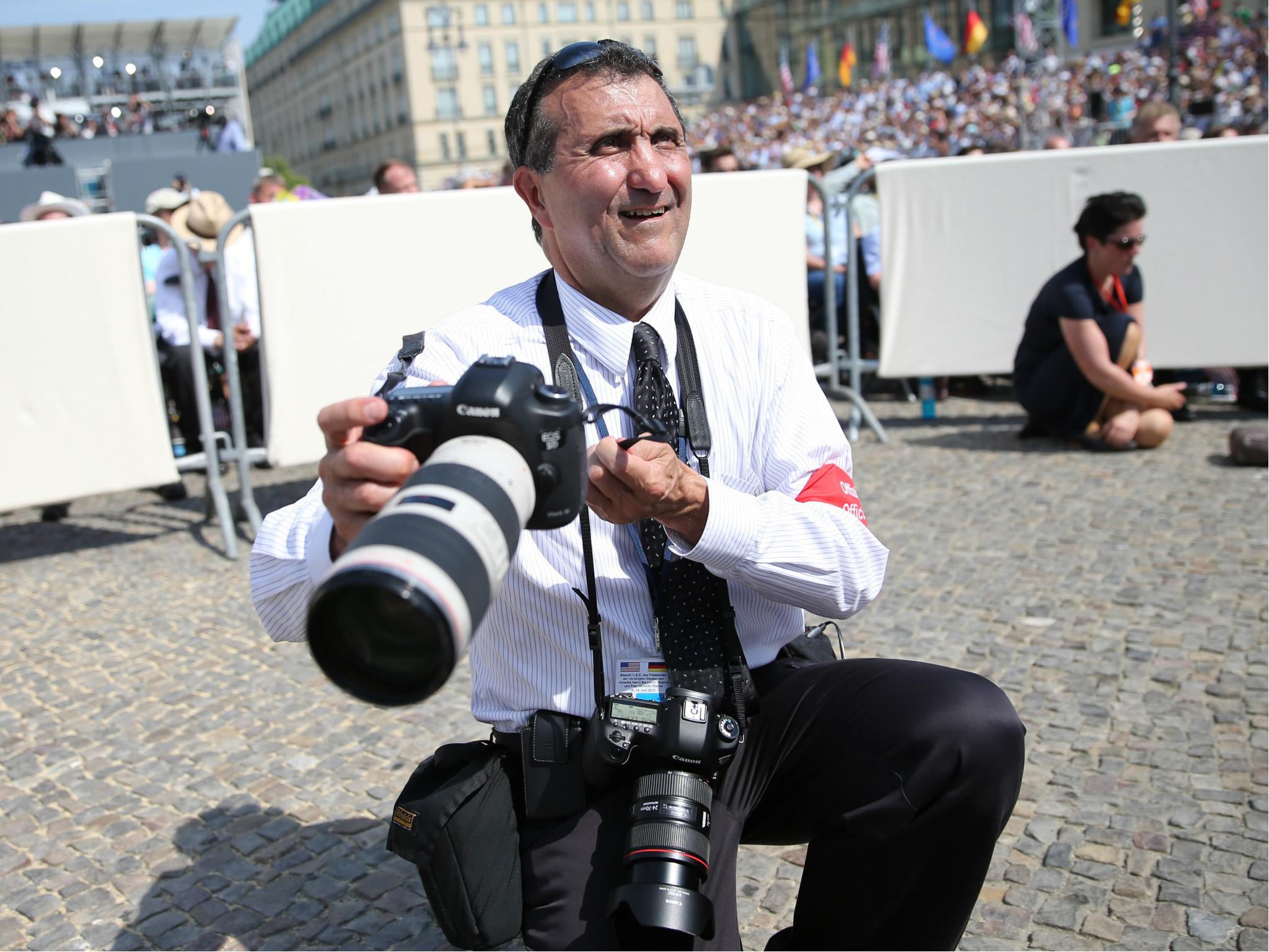 Pete Souza, American photojournalist and Chief Official White House photographer waits for Barack Obama's speech in front of Berlin's Brandenburg Gate 19 June 2013.