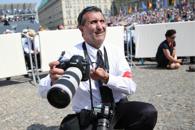 Pete Souza, American photojournalist and Chief Official White House photographer waits for Barack Obama's speech in front of Berlin's Brandenburg Gate 19 June 2013.