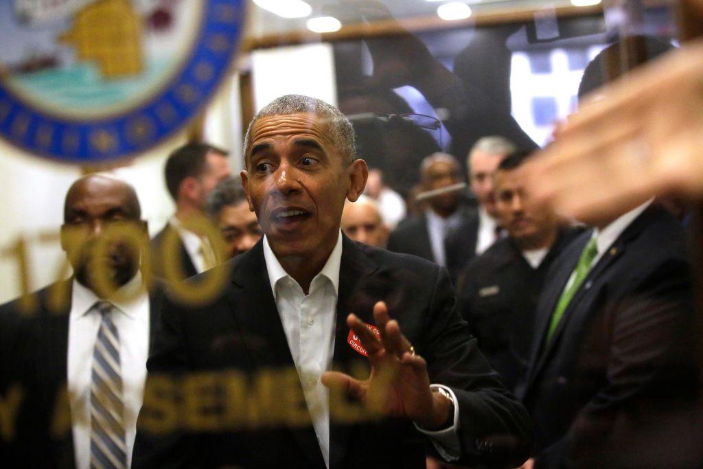 Former President Barack Obama waves to a crowd of people as he attends Cook County jury duty at the Daley Center on November 8, 2017 in Chicago, Illinois.