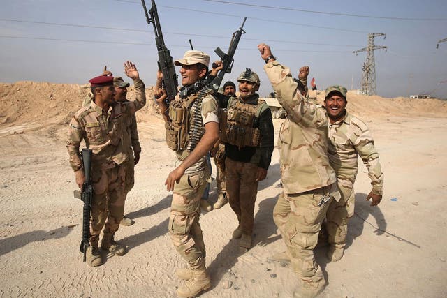 Iraqi forces celebrate near the Syrian border after recapturing a key border town