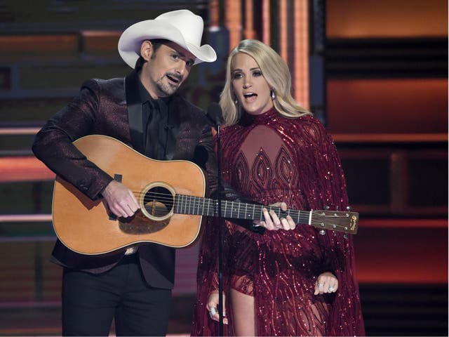 Hosts Brad Paisley and Carrie Underwood appear during the opening of the 51st annual CMA Awards 8 November 2017, in Nashville, Tennessee