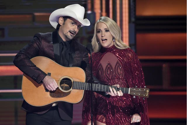 Hosts Brad Paisley and Carrie Underwood appear during the opening of the 51st annual CMA Awards 8 November 2017, in Nashville, Tennessee