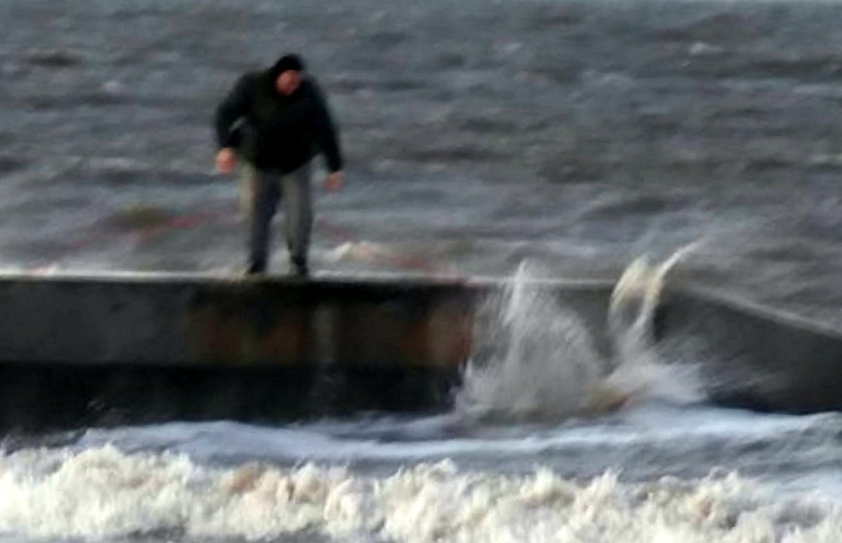 Witnesses captured the moment the dog was thrown into the freezing sea