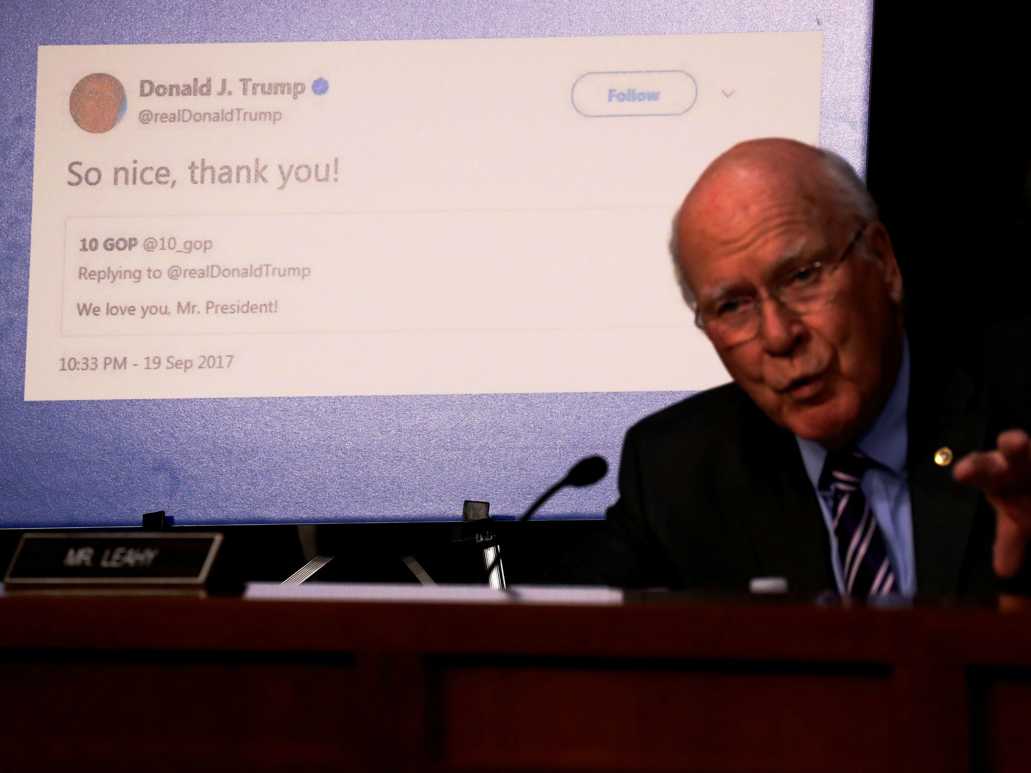 Senator Pat Leahy shows a re-tweet by President Trump of an alleged Russian troll account as representatives of Twitter, Facebook and Google testify before on Capitol Hill on October 31, 2017