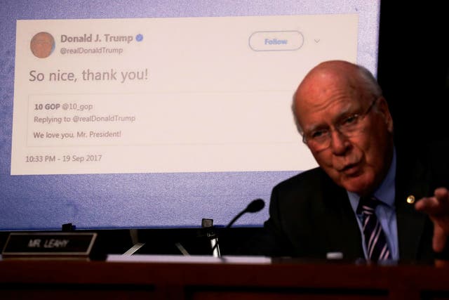 Senator Pat Leahy shows a re-tweet by President Trump of an alleged Russian troll account as representatives of Twitter, Facebook and Google testify before on Capitol Hill on October 31, 2017