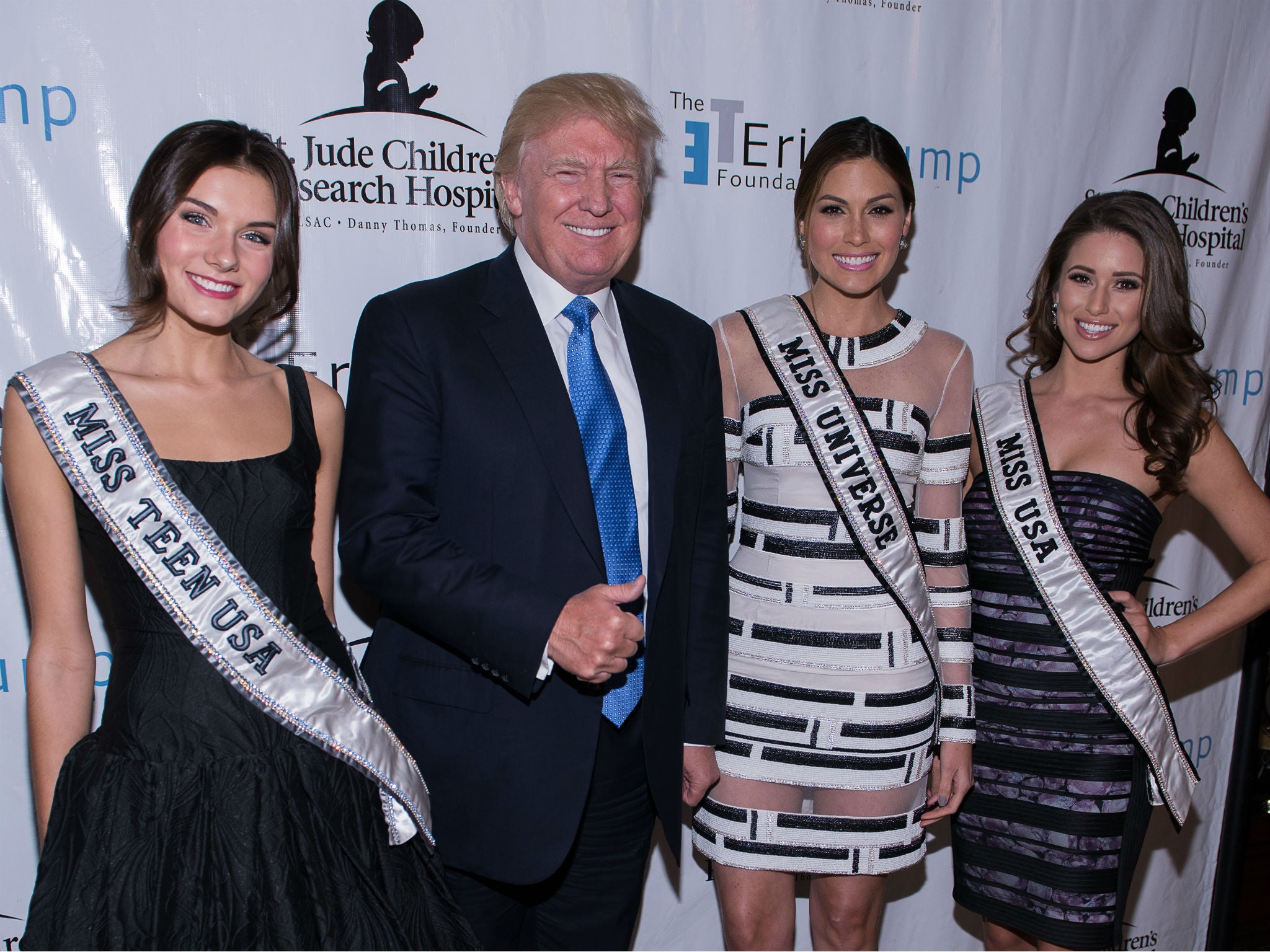 Donald Trump - seen here with beauty pageant contestants on September 15, 2014 in Briarcliff Manor, New York - was allegedly offered women when he was in Moscow promoting Miss Universe, a separate pageant