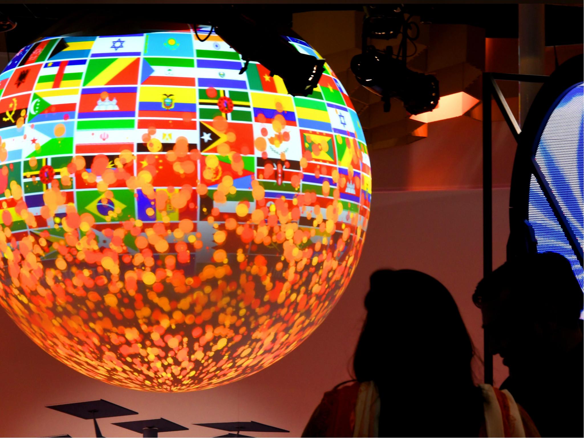 Visitors look at a sphere displayed at the pavillion of India on 8 November 2017 during the COP23 United Nations Climate Change Conference in Bonn, Germany.