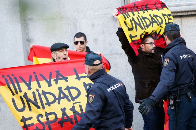 Right-wind protesters holding Spanish flags reading 'Long live a united Spain' outside the Supreme Court in Madrid