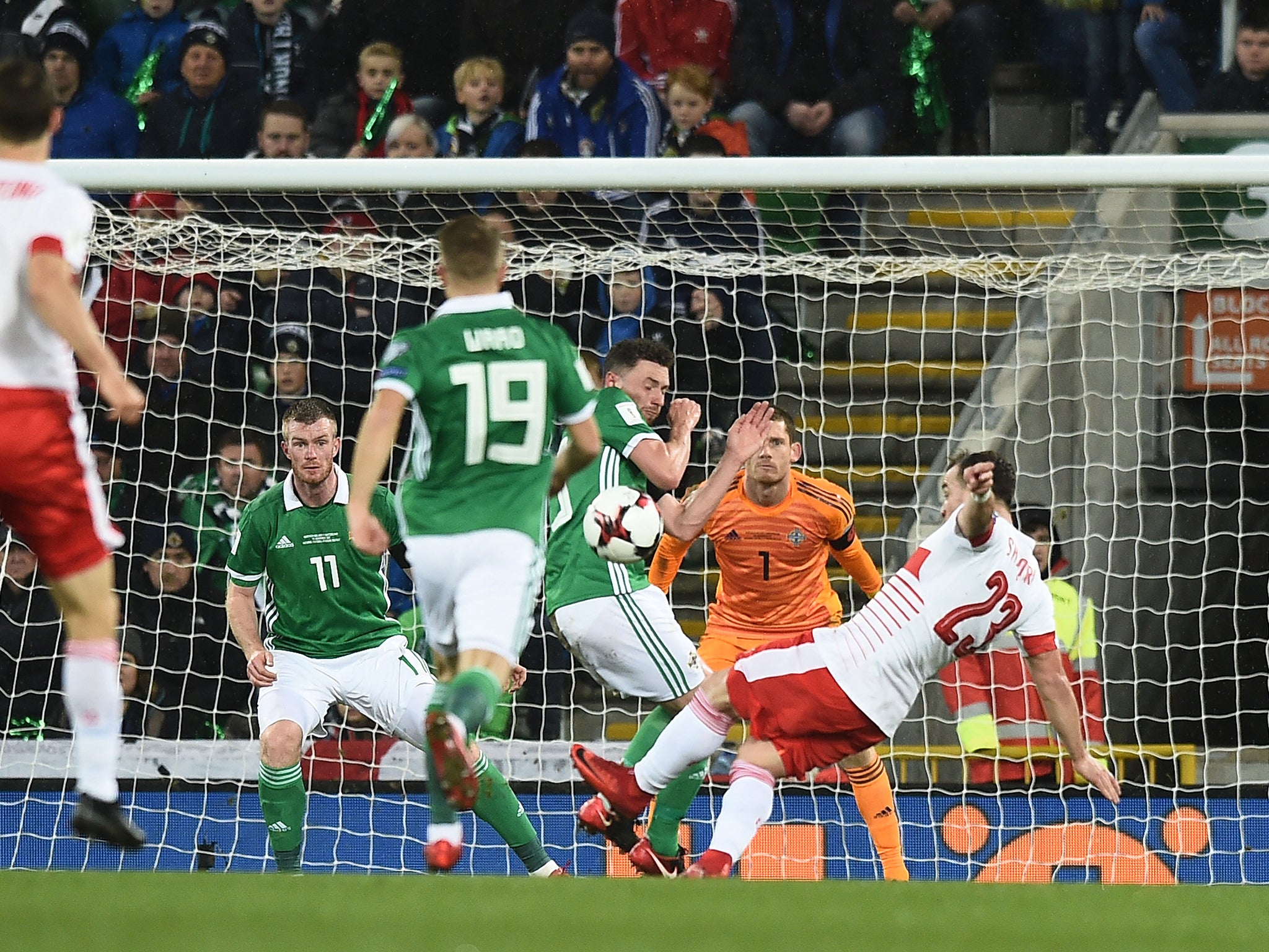 Xherdan Shaqiri's shot hits Corry Evans and leads to a penalty for Switzerland against Northern Ireland
