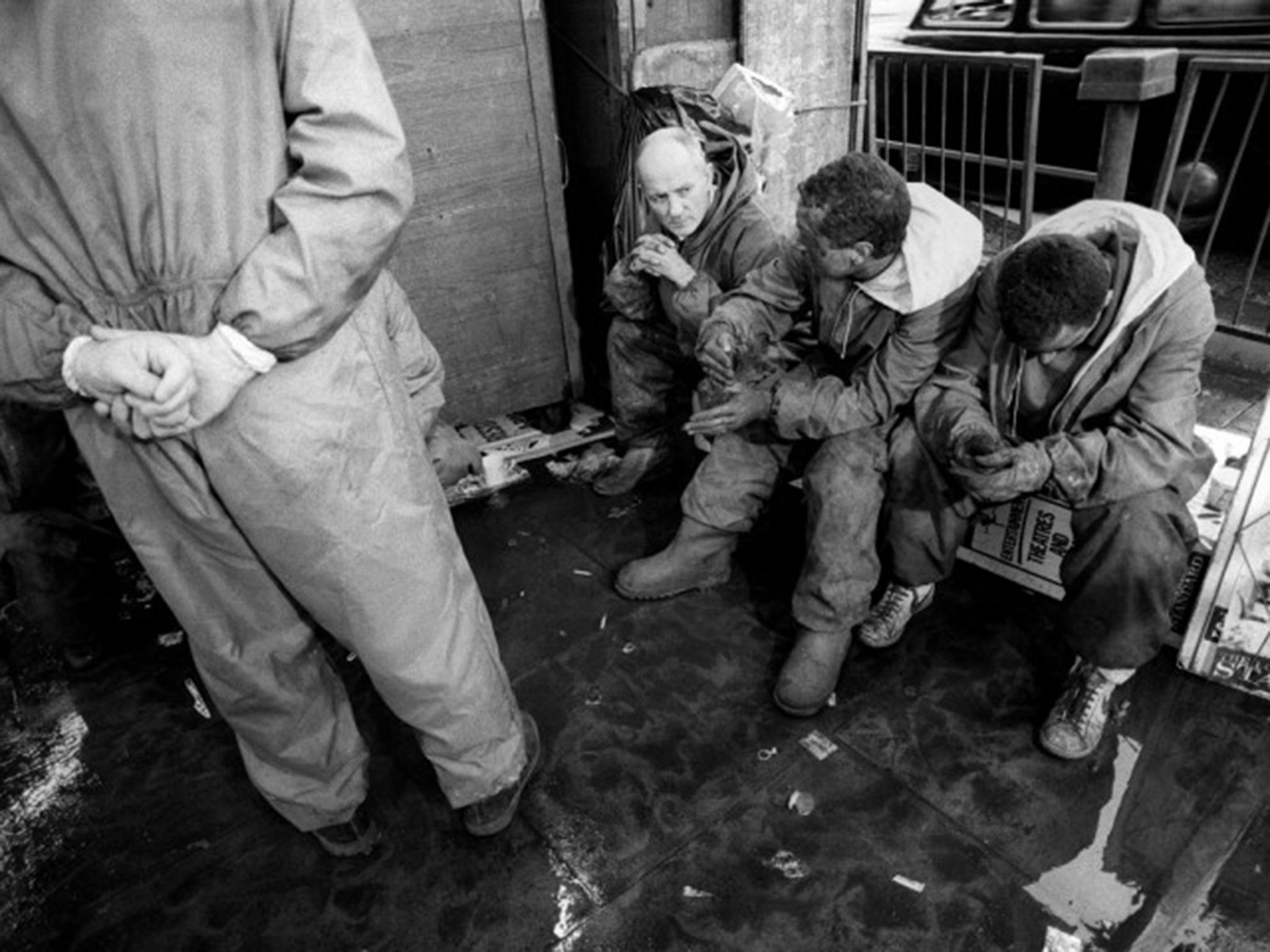 Devastated workers rest outside the station during the King’s Cross Tube fire disaster