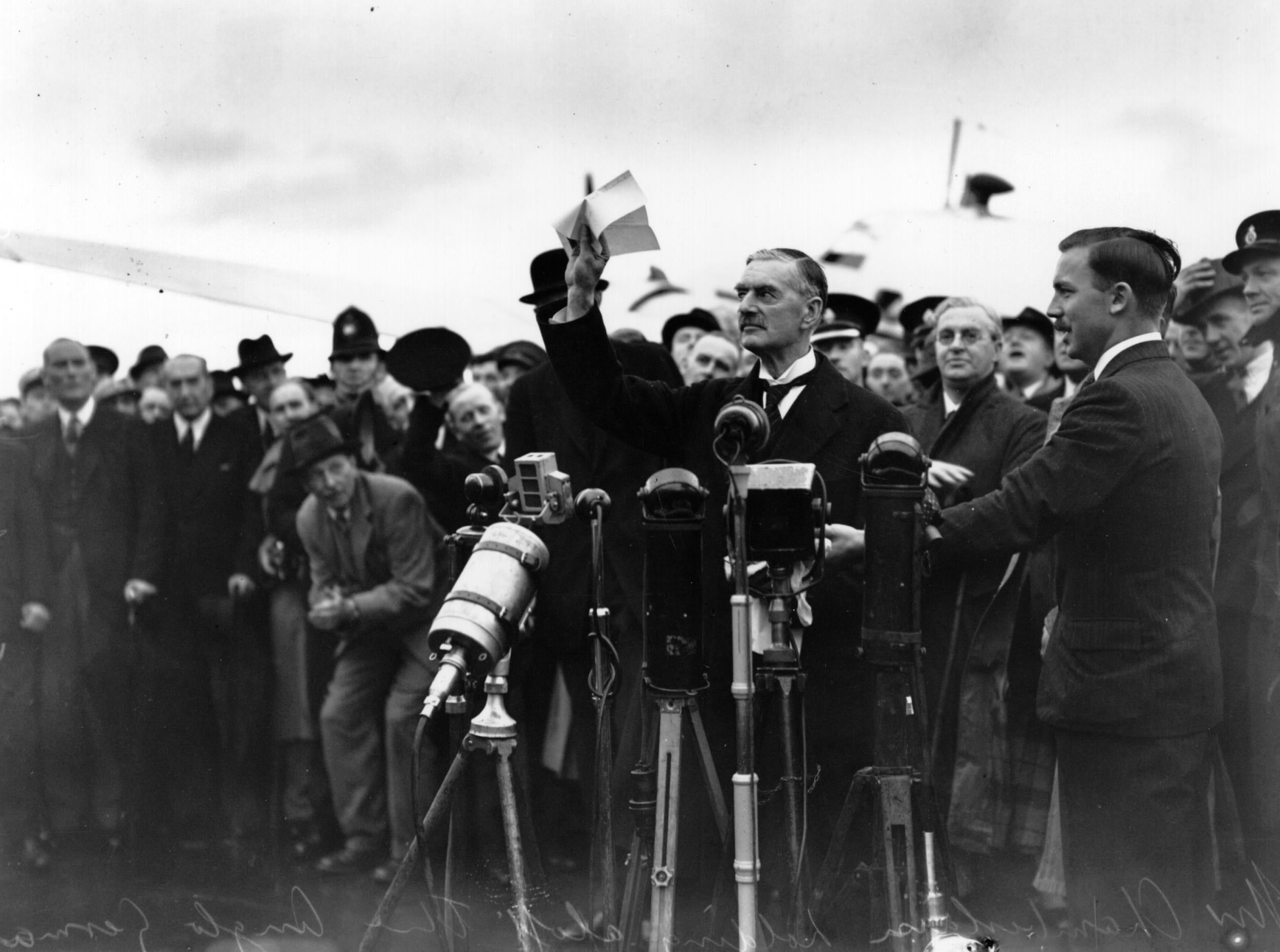 Something to declare: Neville Chamberlain (right) speaks in front of a Lockheed 14 in 1938