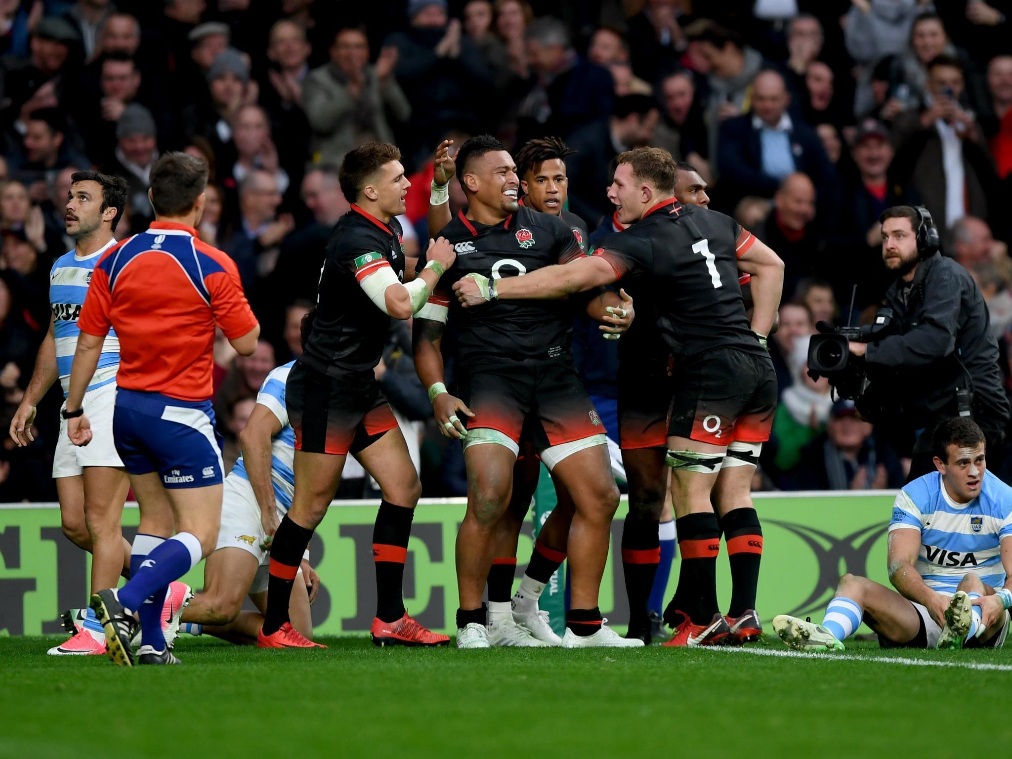 England celebrate after Nathan Hughes scores a try against Argentina