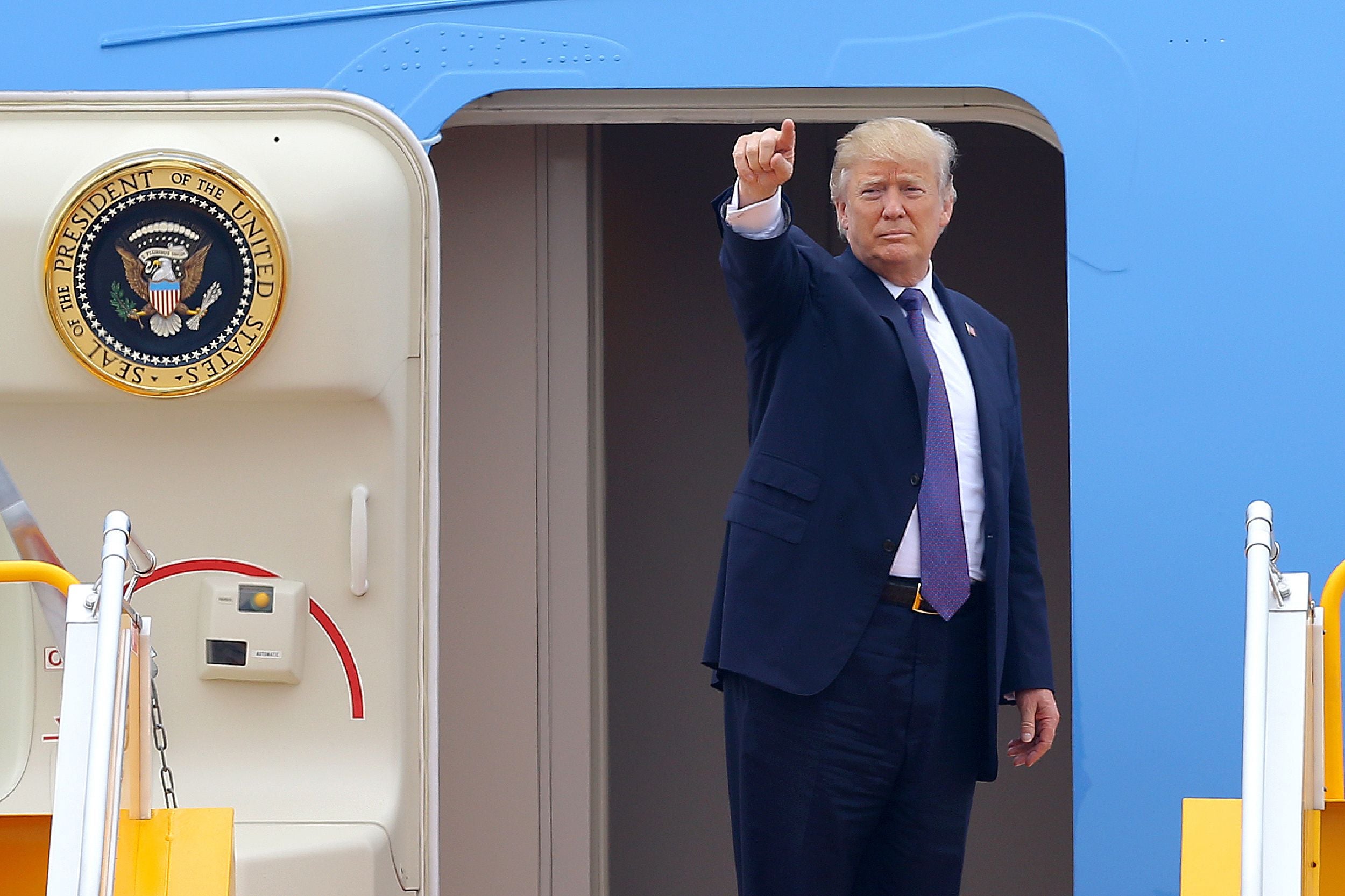 US President Donald Trump gestures as he boards Air Force One
