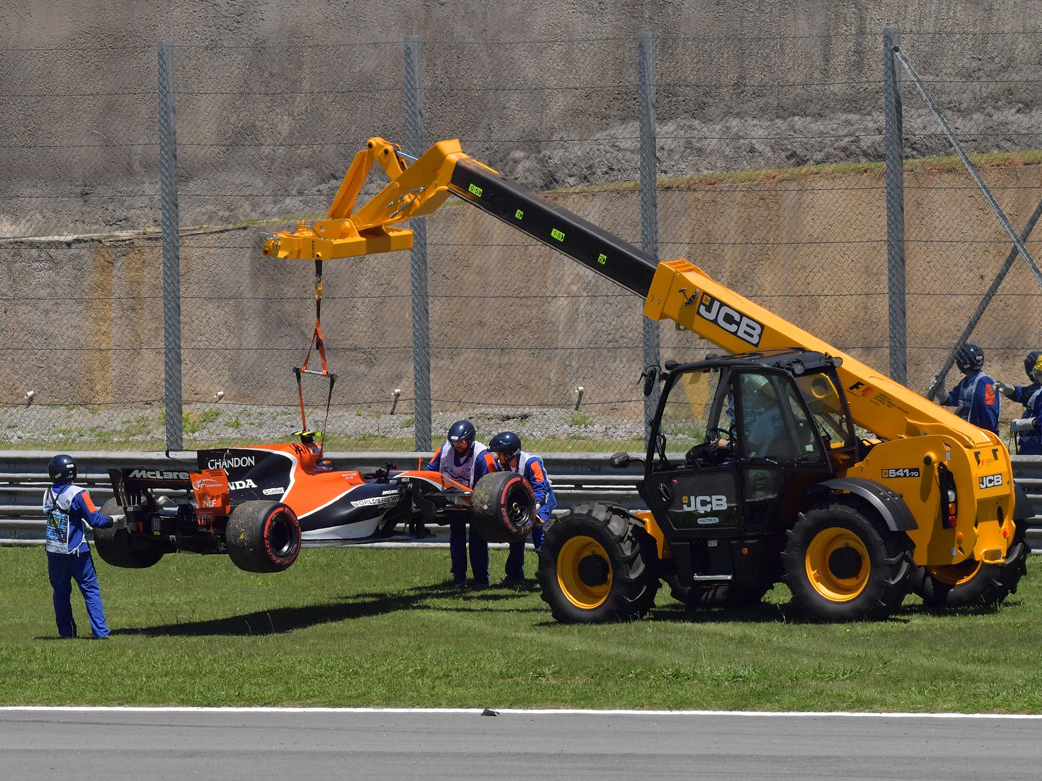 Vandoorne's stricken McLaren is winched off the track