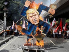 Trump hails 'red carpet like never before' as his effigy is burned