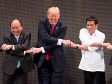 Donald Trump baffled by group handshake with fellow leaders