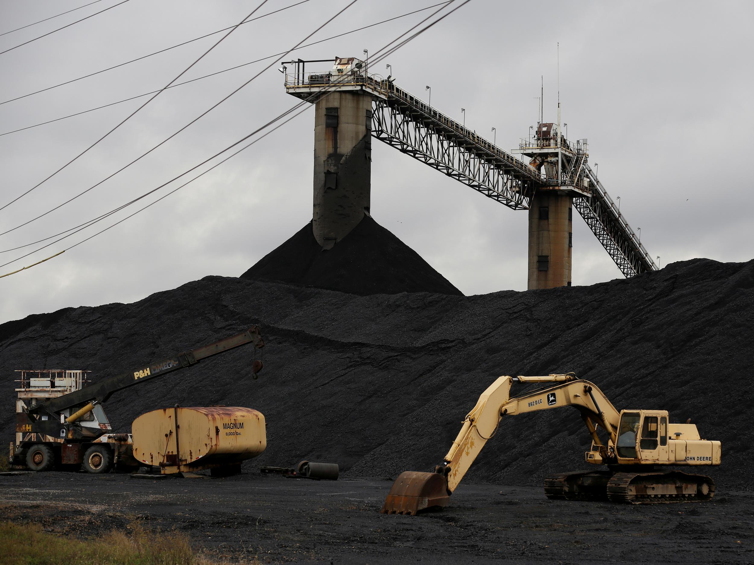 Earth moving equipment sits by a coal pile at the Century Mine in Beallsville, Ohio