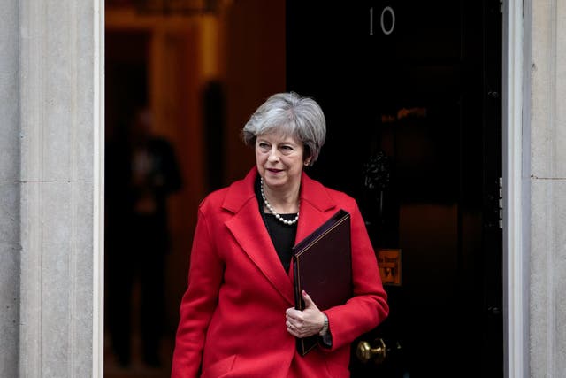 Theresa May leaves Number 10 Downing Street to hold a meeting with European business leaders