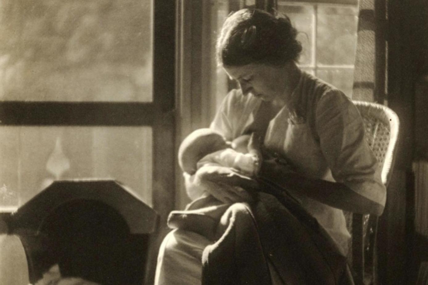 A mother breastfeeding a child, USA, circa 1910.