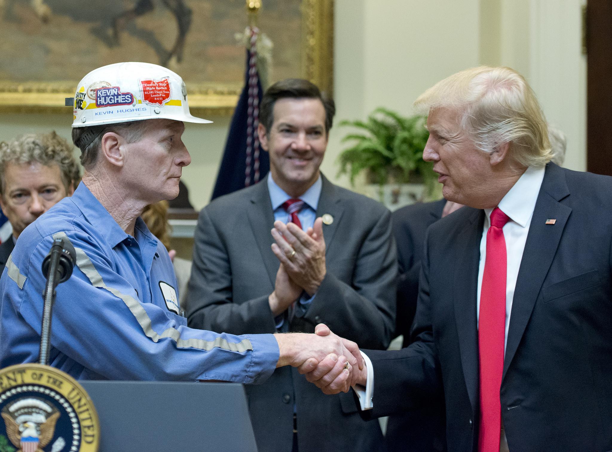 A coal miner identified as Kevin shakes hands with U.S. President Donald Trump prior to the President signing H.J. Res. 38, disapproving the rule submitted by the US Department of the Interior known as the Stream Protection Rule in the Roosevelt Room of the White House on February 16, 2017 in Washington, DC