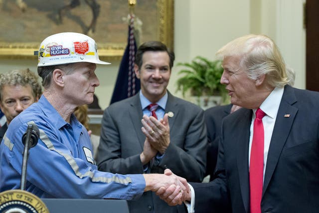 A coal miner identified as Kevin shakes hands with U.S. President Donald Trump prior to the President signing H.J. Res. 38, disapproving the rule submitted by the US Department of the Interior known as the Stream Protection Rule in the Roosevelt Room of the White House on February 16, 2017 in Washington, DC