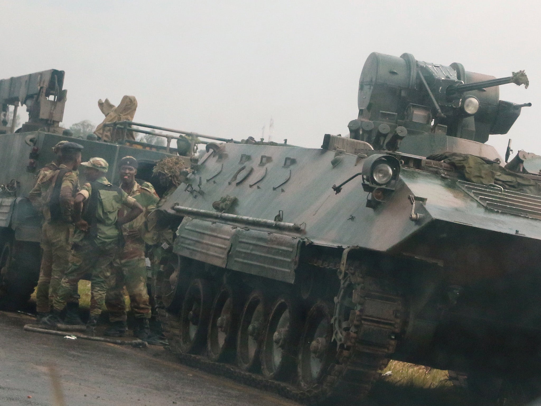 Soldiers stand beside military vehicles just outside Zimbawe's capital Harare