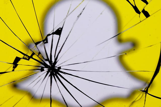 A Snapchat logo is seen through broken glass in this illustration picture, May 11, 2017