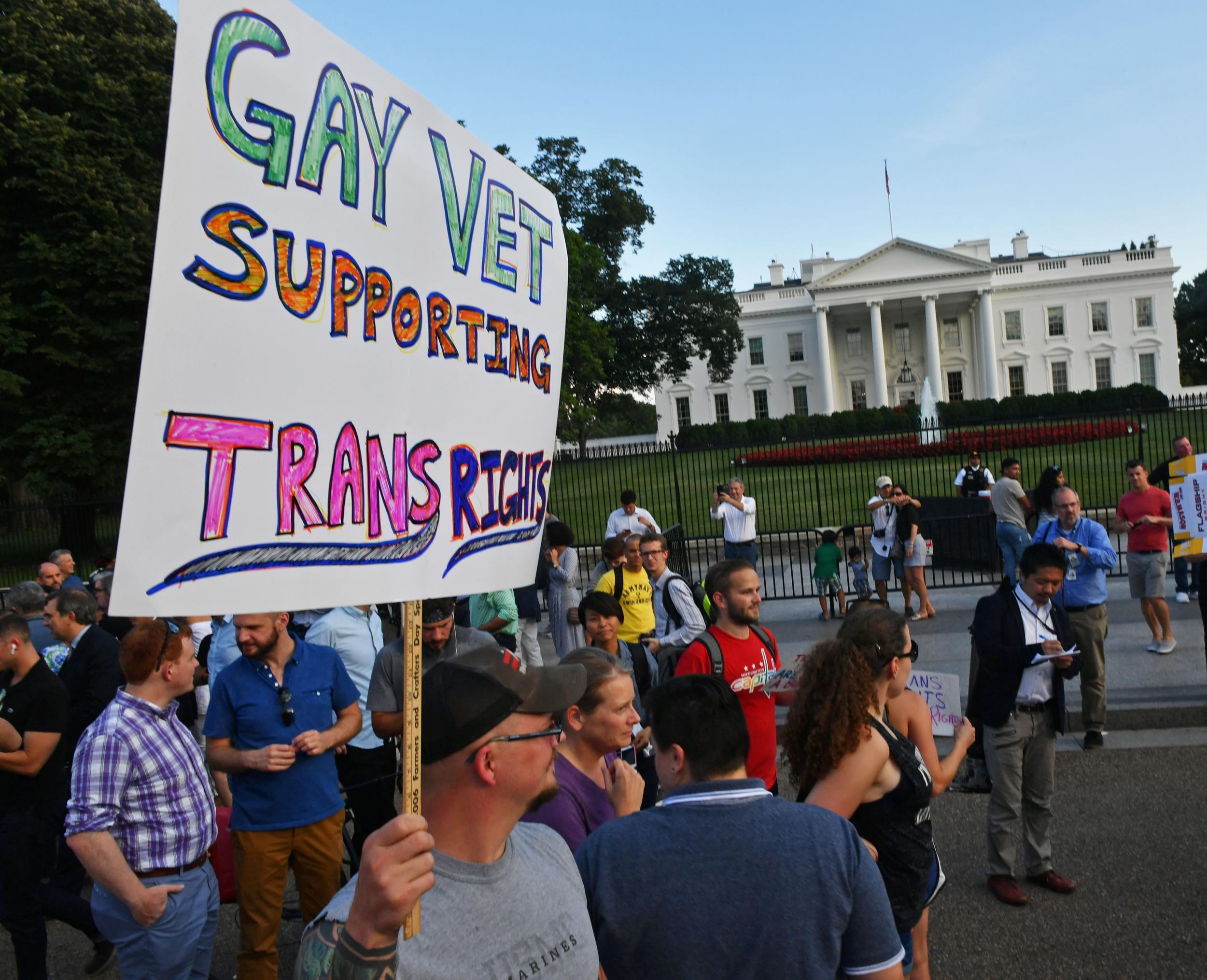 Protesters gather in front of the White House after Donald Trump announces his ban on transgender troops