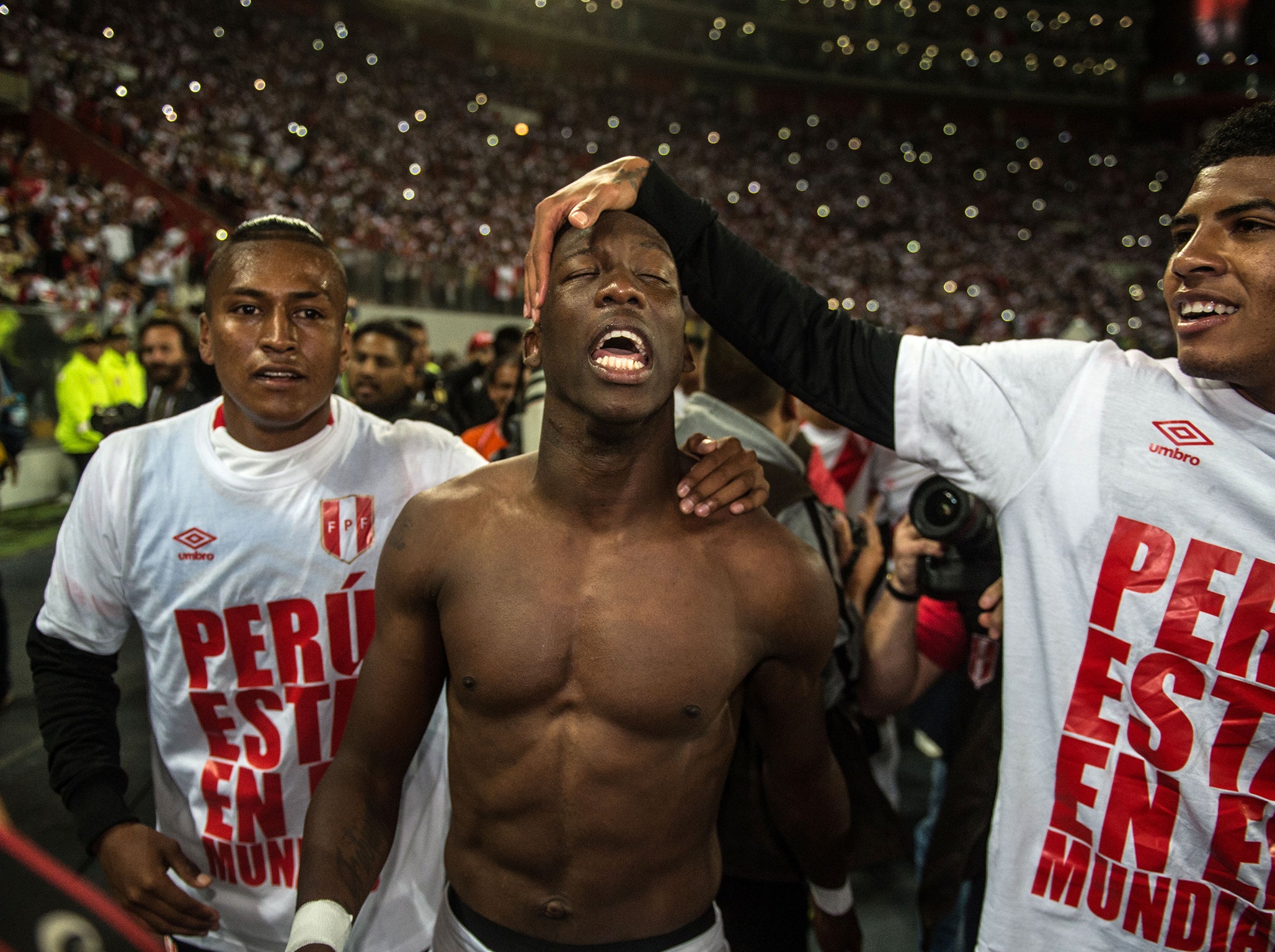 Peru's Luis Advincula (C) celebrates with teammates after defeating New Zealand 2-0