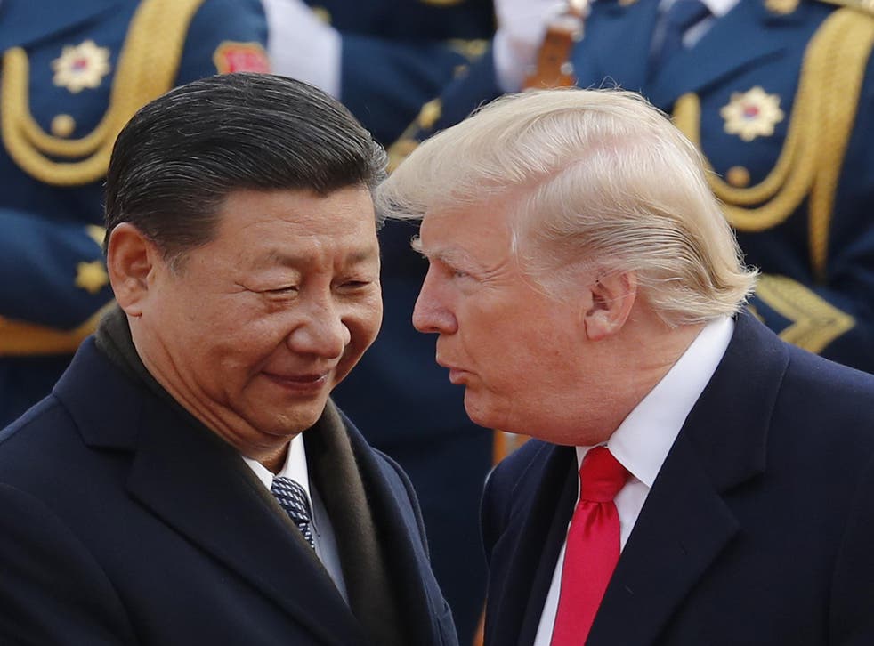 US President Donald Trump chats with Chinese President Xi Jinping during a welcome ceremony in Beijing on 9 November