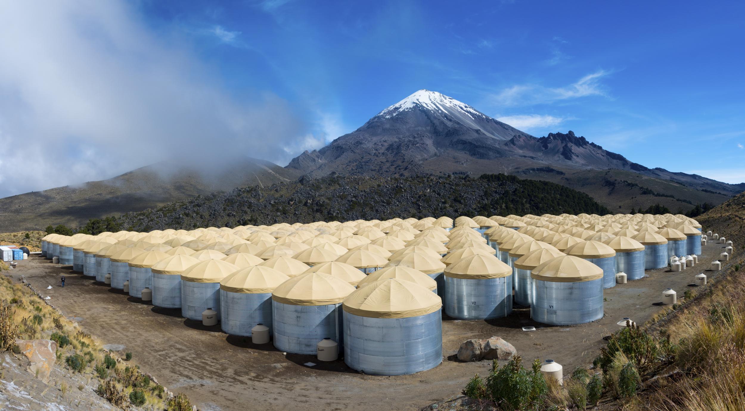 An image of the HAWC detector consisting of 300 large (188,000 liter/50k gallon) water tanks, each with 4 photodetectors