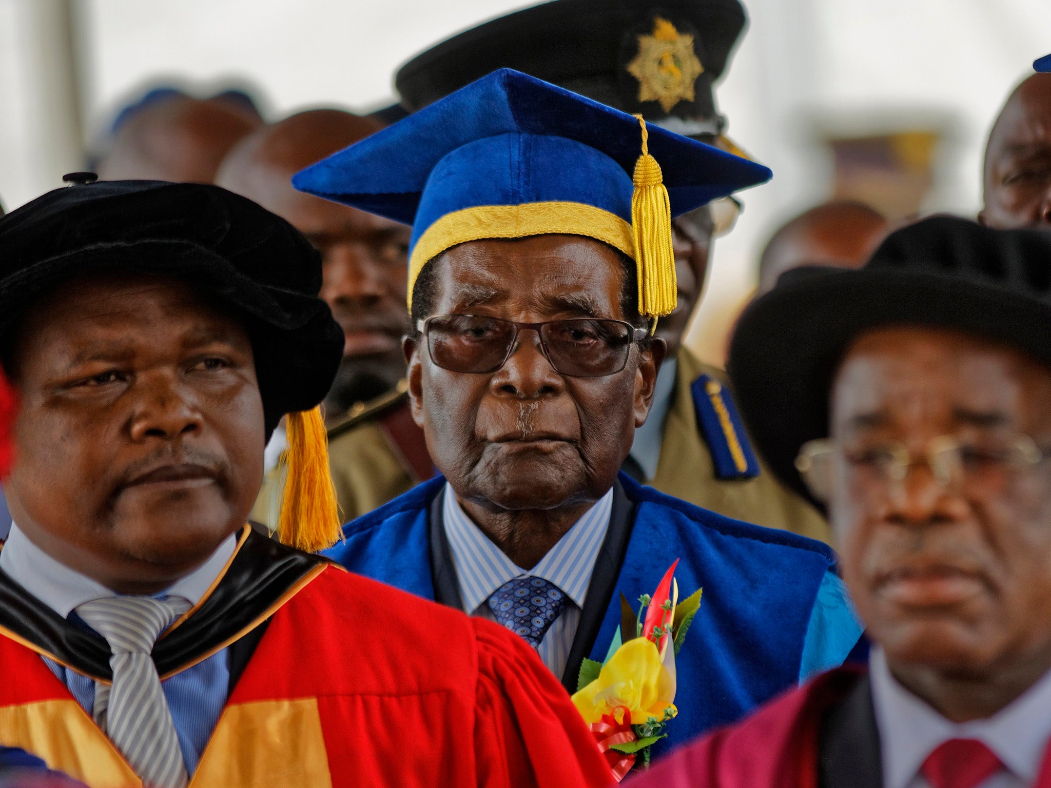 Robert Mugabe presides over a student graduation ceremony at Zimbabwe Open University yesterday, his first public appearance since the military put him under house arrest