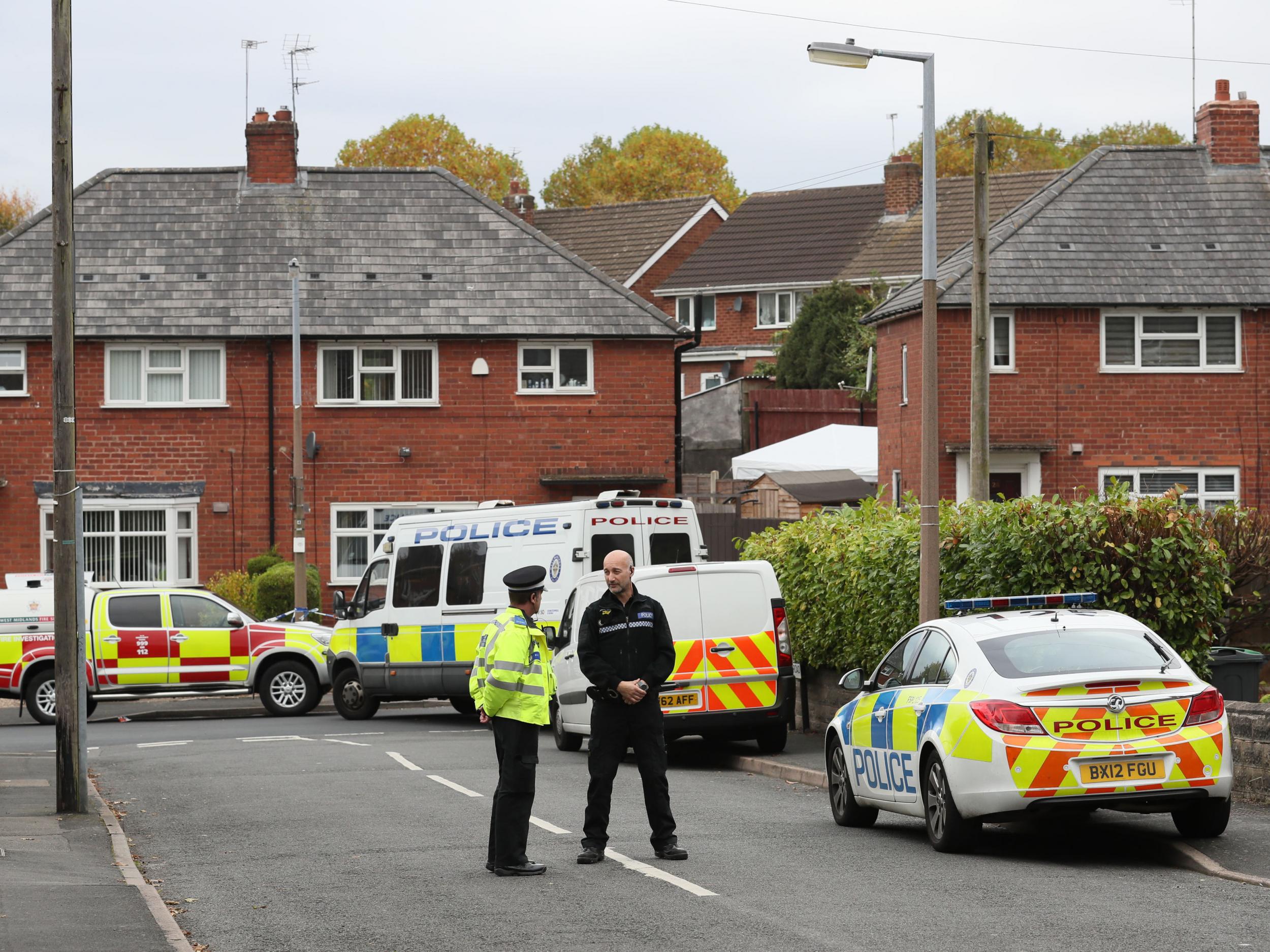 Police at the scene in Holland Road, Hamstead, Birmingham, after a boy and a girl died in a house fire