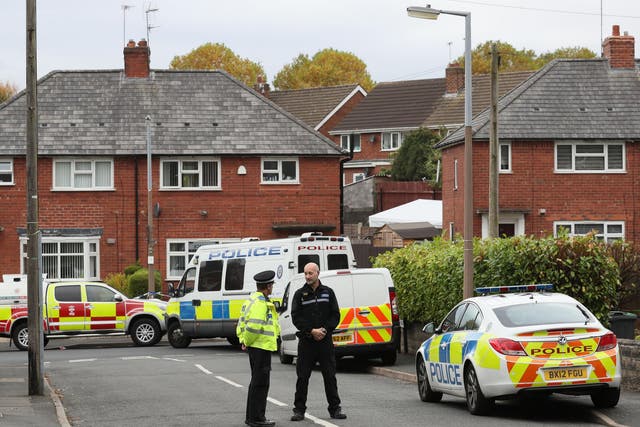 Police at the scene in Holland Road, Hamstead, Birmingham, after a boy and a girl died in a house fire