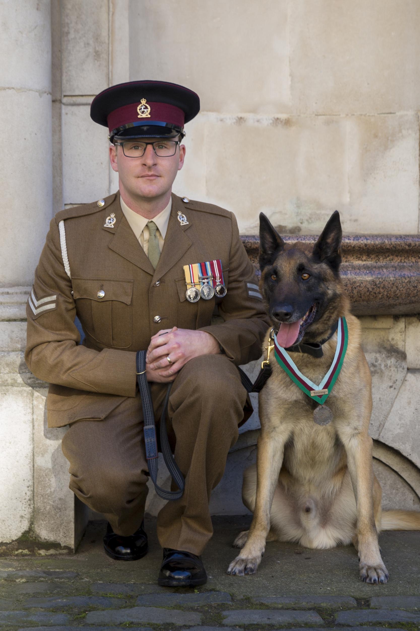 Mali, sporting his medal, with handler Corporal Daniel Hatley