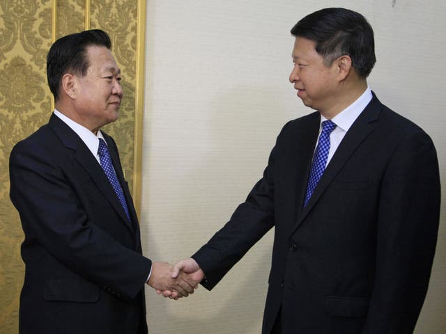 Song Tao (right) met with Choe Ryong Hae when he arrived in Pyongyang