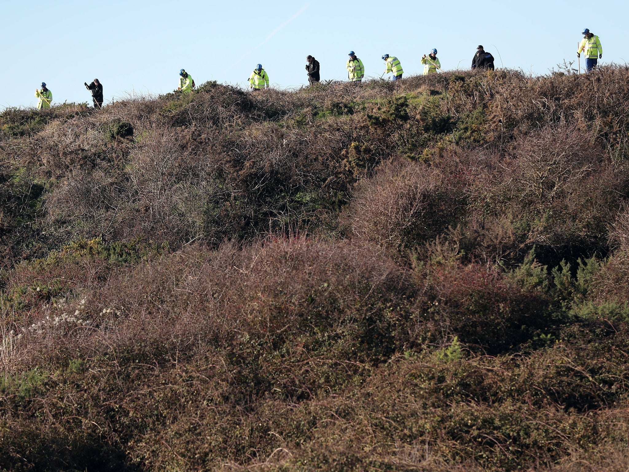 Investigators perform a fingertip search of an area in Swanage in the search for Gaia Pope