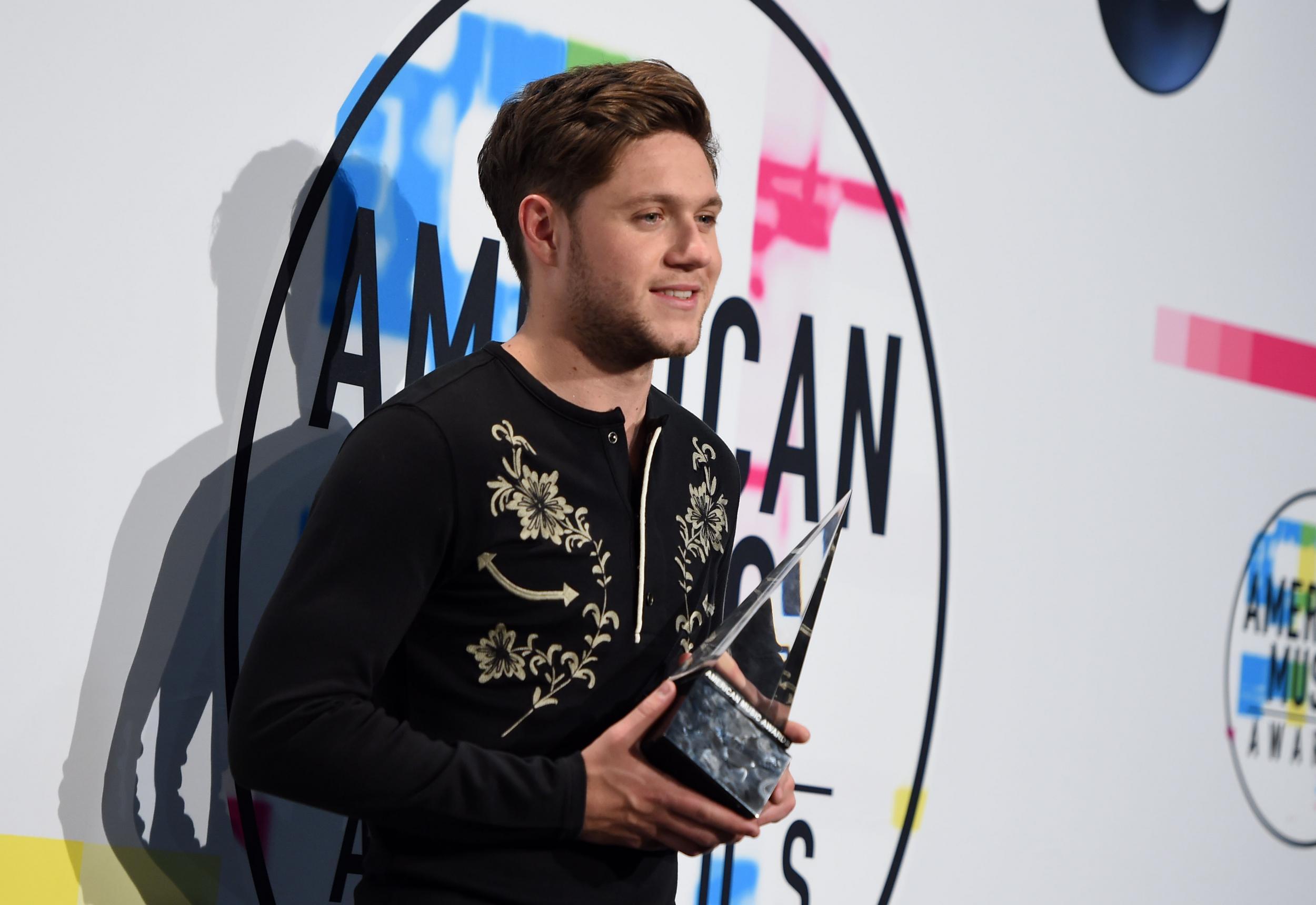 Niall Horan poses with his Best New Artist award at the AMAs