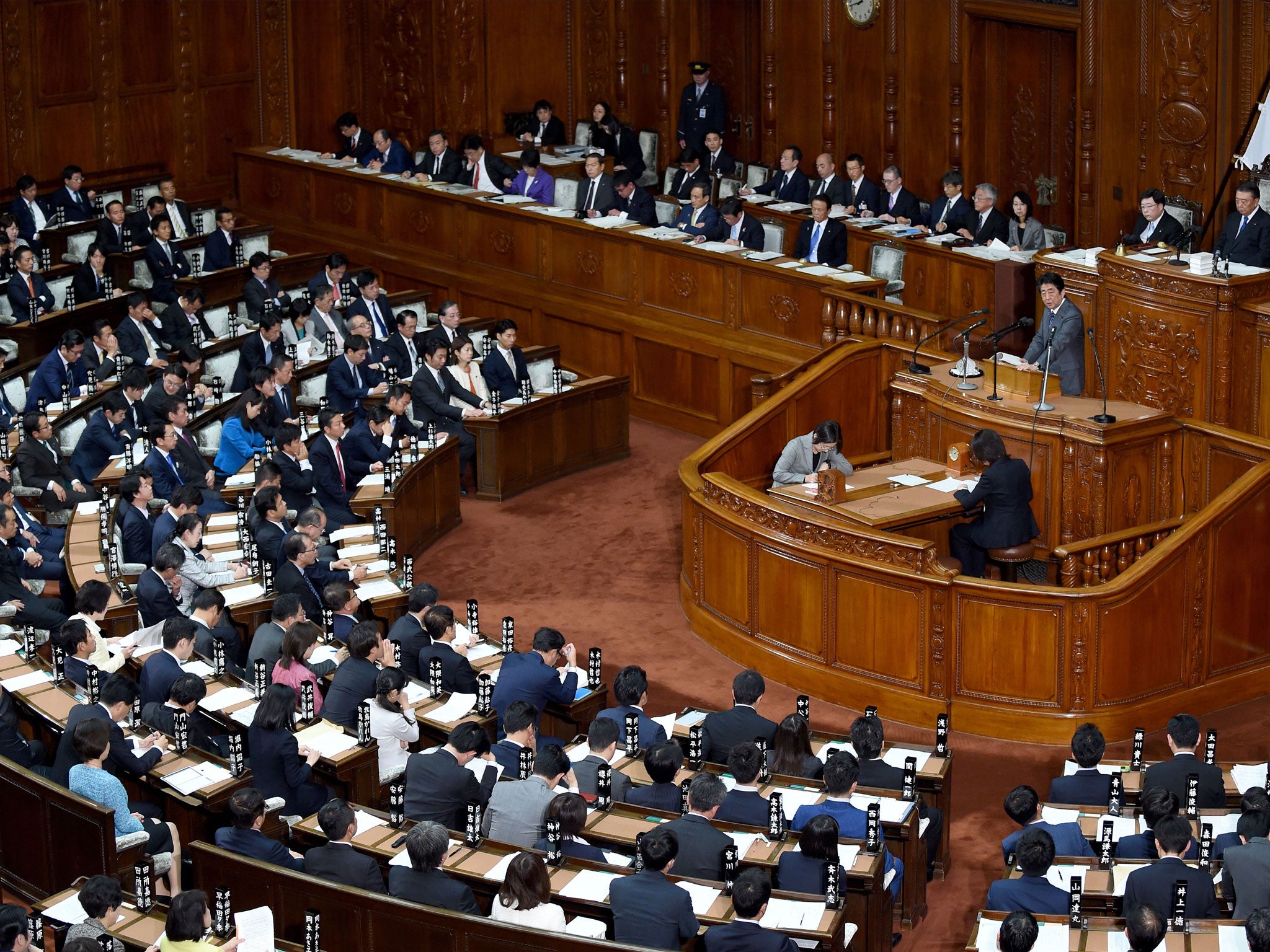 Shinzo Abe answers questions during a session of the lower house of parliament in Tokyo on 20 November