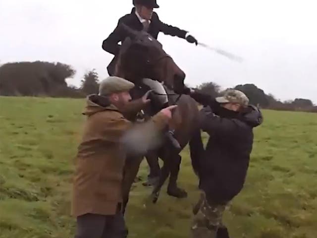 Video footage shows the huntswoman whipping the protester