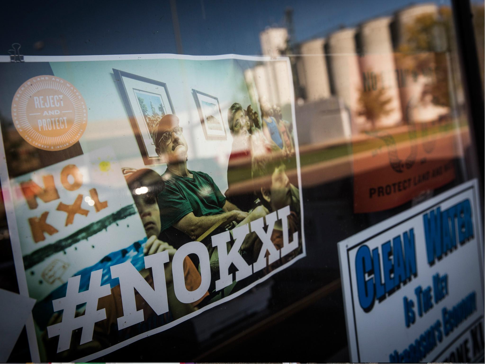 Signs against the proposed Keystone XL pipeline are taped to the window a hardware store on 11 October 2014 in Polk, Nebraska.
