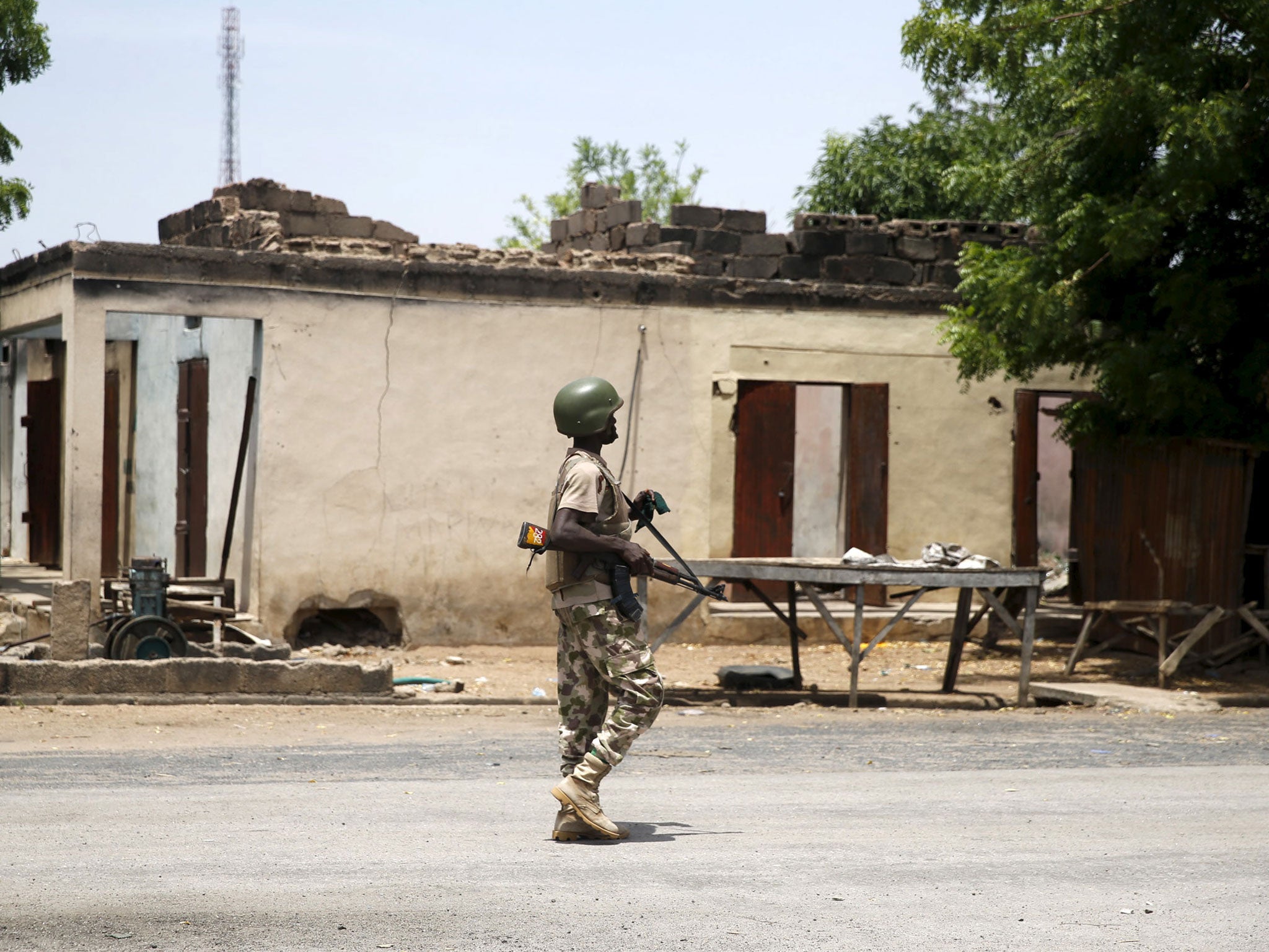 A soldier walks past a burnt building in Michika town in Adamawa state in 2015 after the Nigerian military recaptured it from Boko Haram